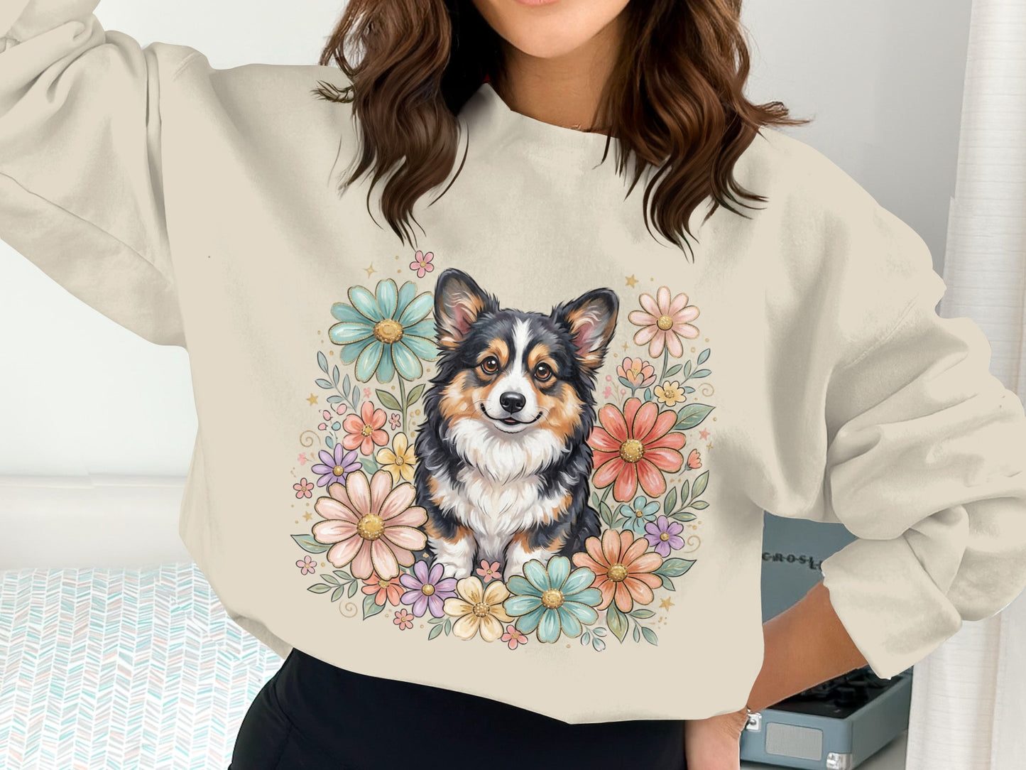 Corgi dog surrounded by colorful flowers on a light beige crewneck sweatshirt.