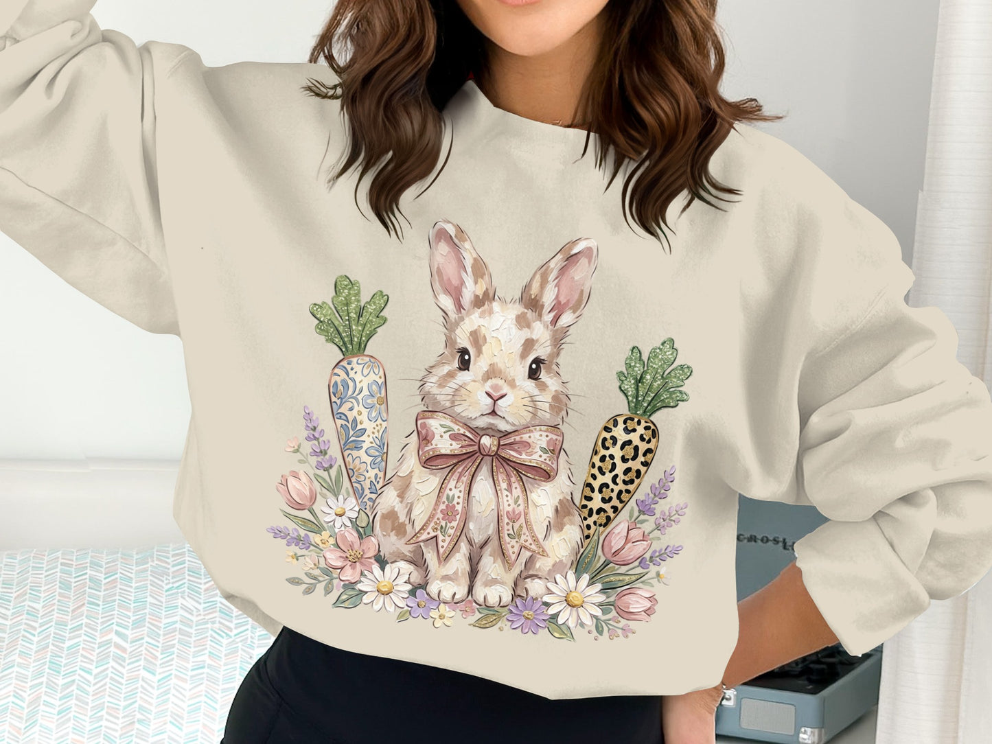 Cream sweatshirt with a whimsical bunny, carrots, and floral accents.