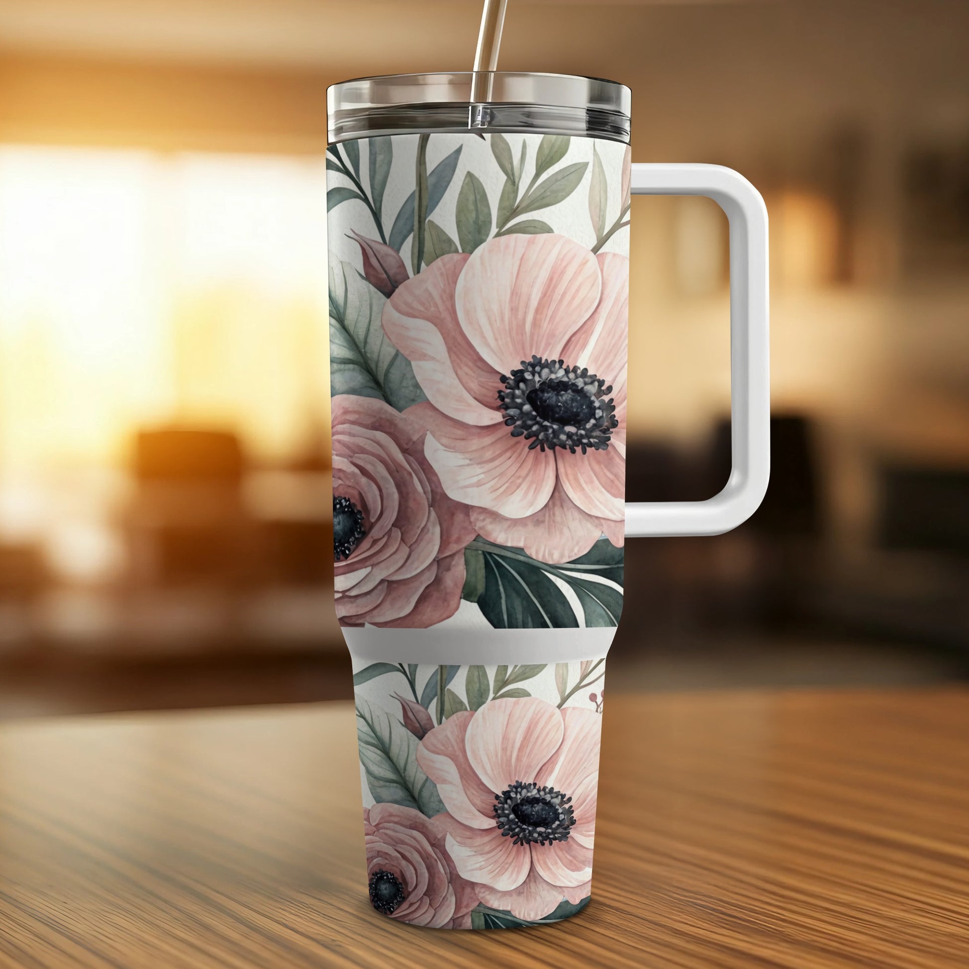 Tumbler with floral pattern of pink roses and green leaves.