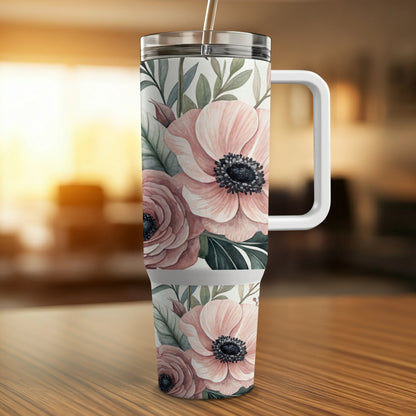 Tumbler with floral pattern of pink roses and green leaves.