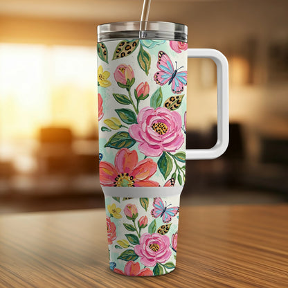 Floral tumbler with butterflies and leopard print accents, featuring a straw and handle.