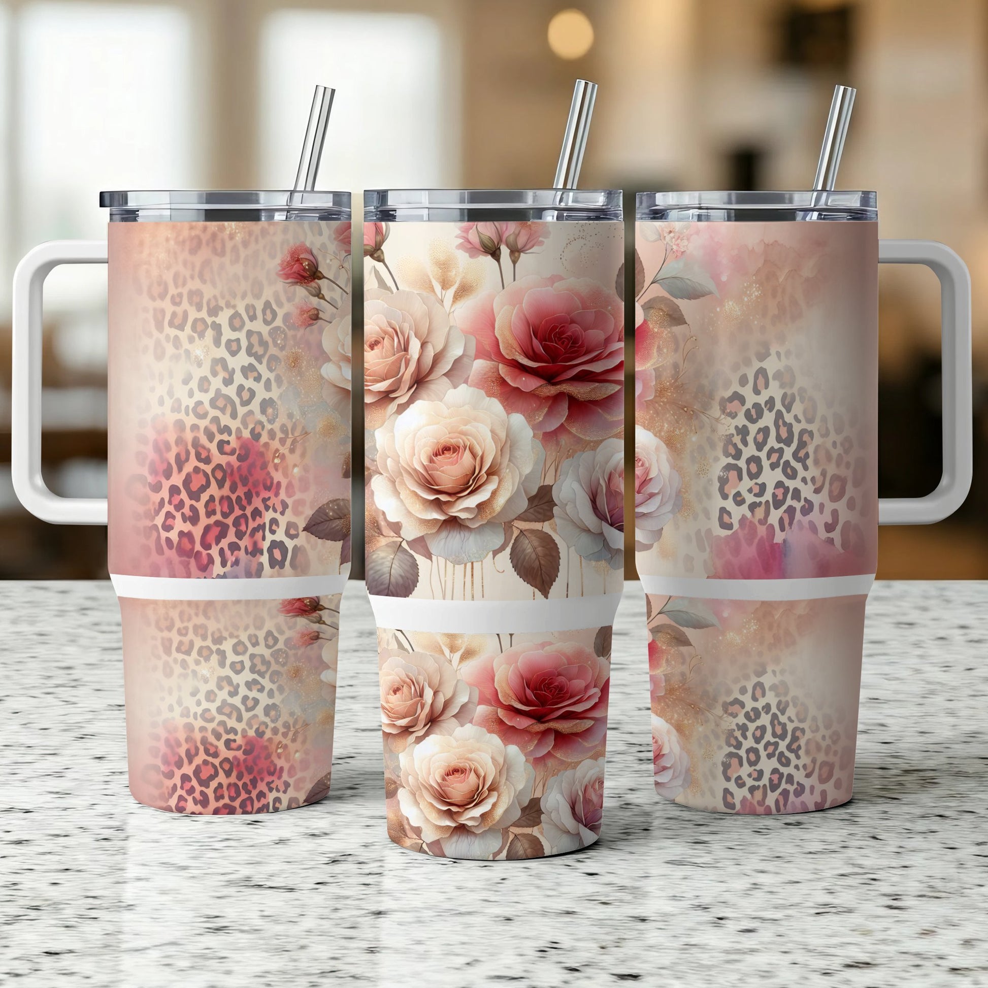 Three tumblers with floral and leopard print designs sit on a speckled surface.