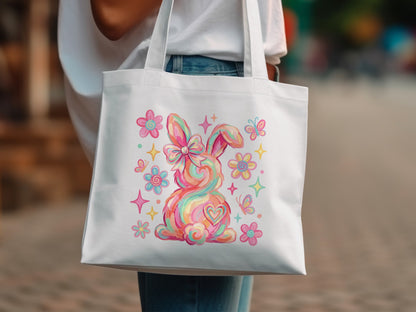 White tote bag with a colorful rainbow bunny and flowers.