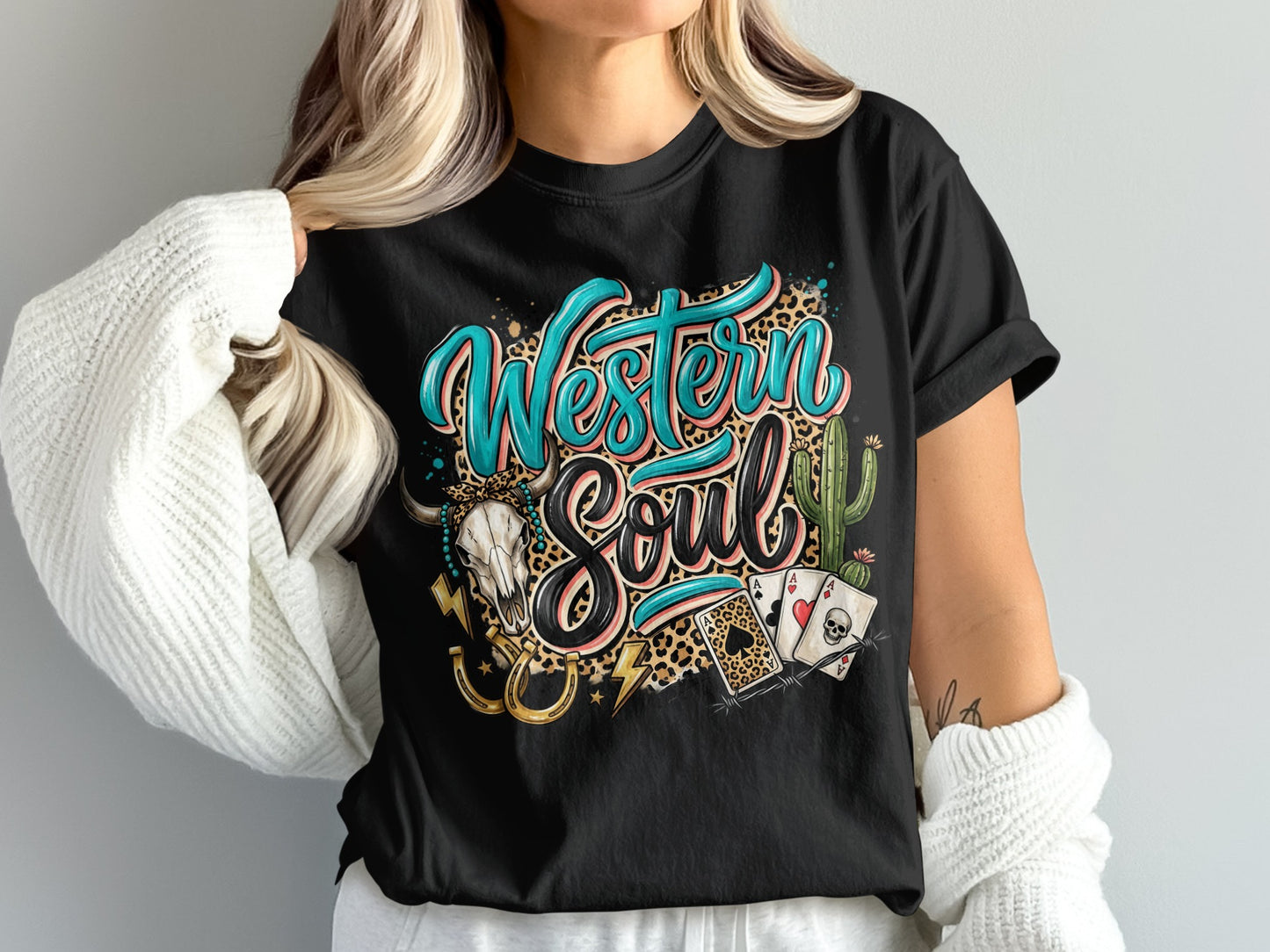 Western Soul text with leopard print, skull, horseshoe, and cards on black t-shirt.