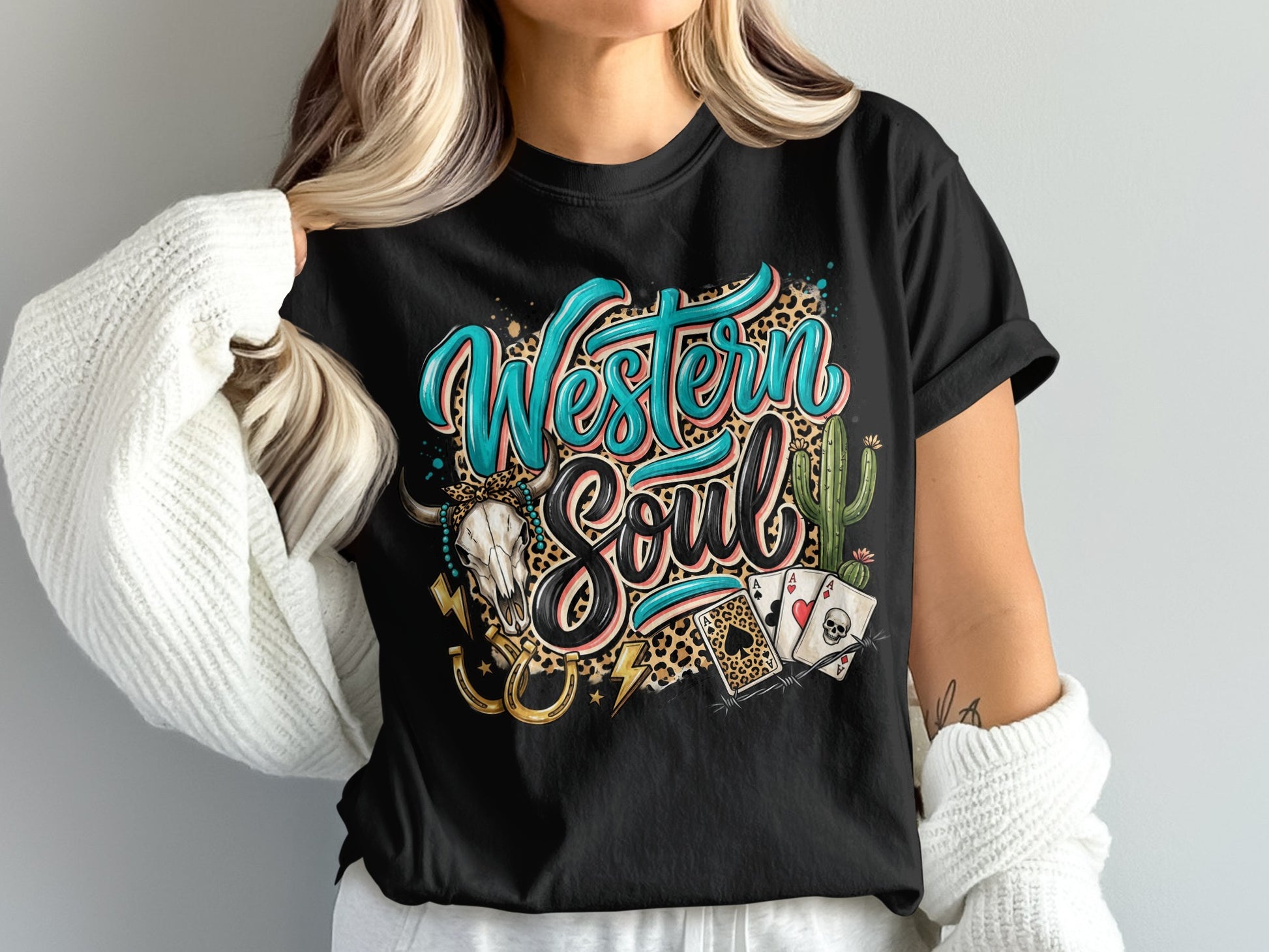 Western Soul text with leopard print, skull, horseshoe, and cards on black t-shirt.