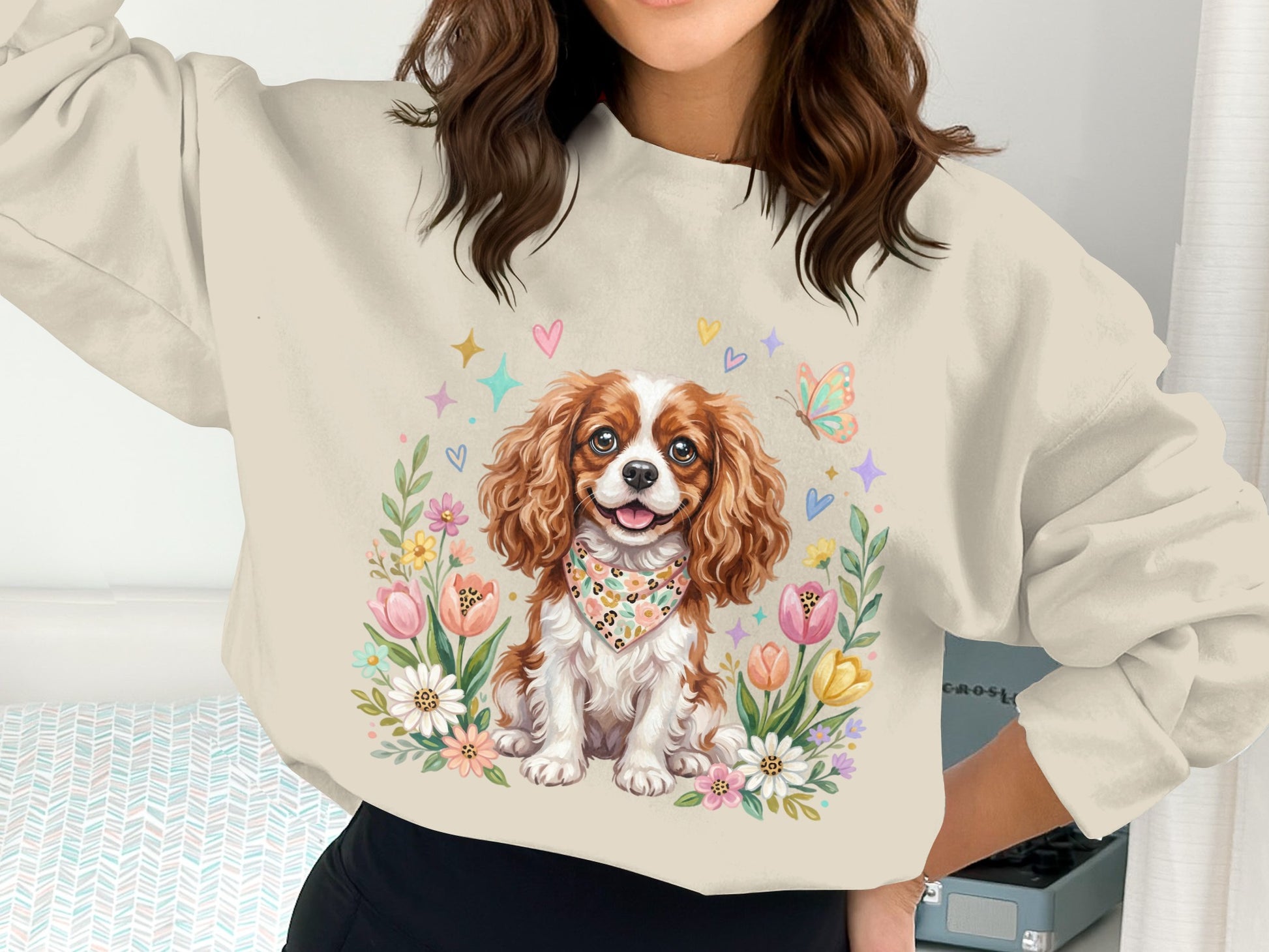 Cavalier King Charles Spaniel wearing bandana surrounded by flowers and hearts.