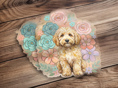 Golden doodle puppy surrounded by pastel flowers on a wooden background.