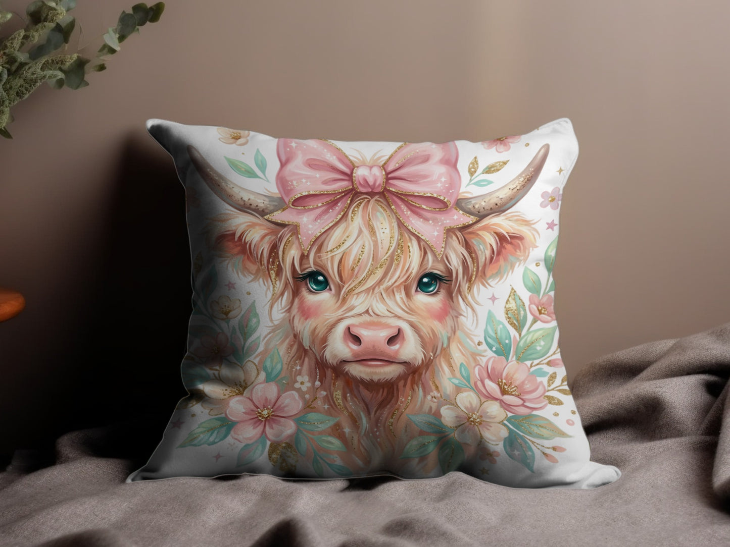 Highland cow with pink bow and floral accents on a pillow.