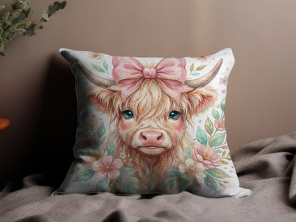 Highland cow with pink bow and floral accents on a pillow.
