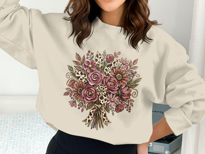 Cream sweatshirt with a large floral bouquet print and leopard print bow.