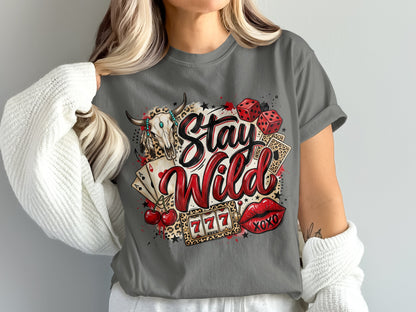 Skull, dice, cards, cherries, lips, and "Stay Wild" text on a gray t-shirt.
