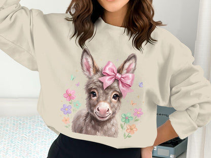 Sweatshirt with a cute donkey wearing a pink bow, surrounded by flowers.