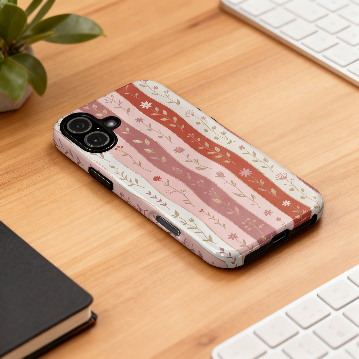 Phone case with a pink and white floral stripe pattern.