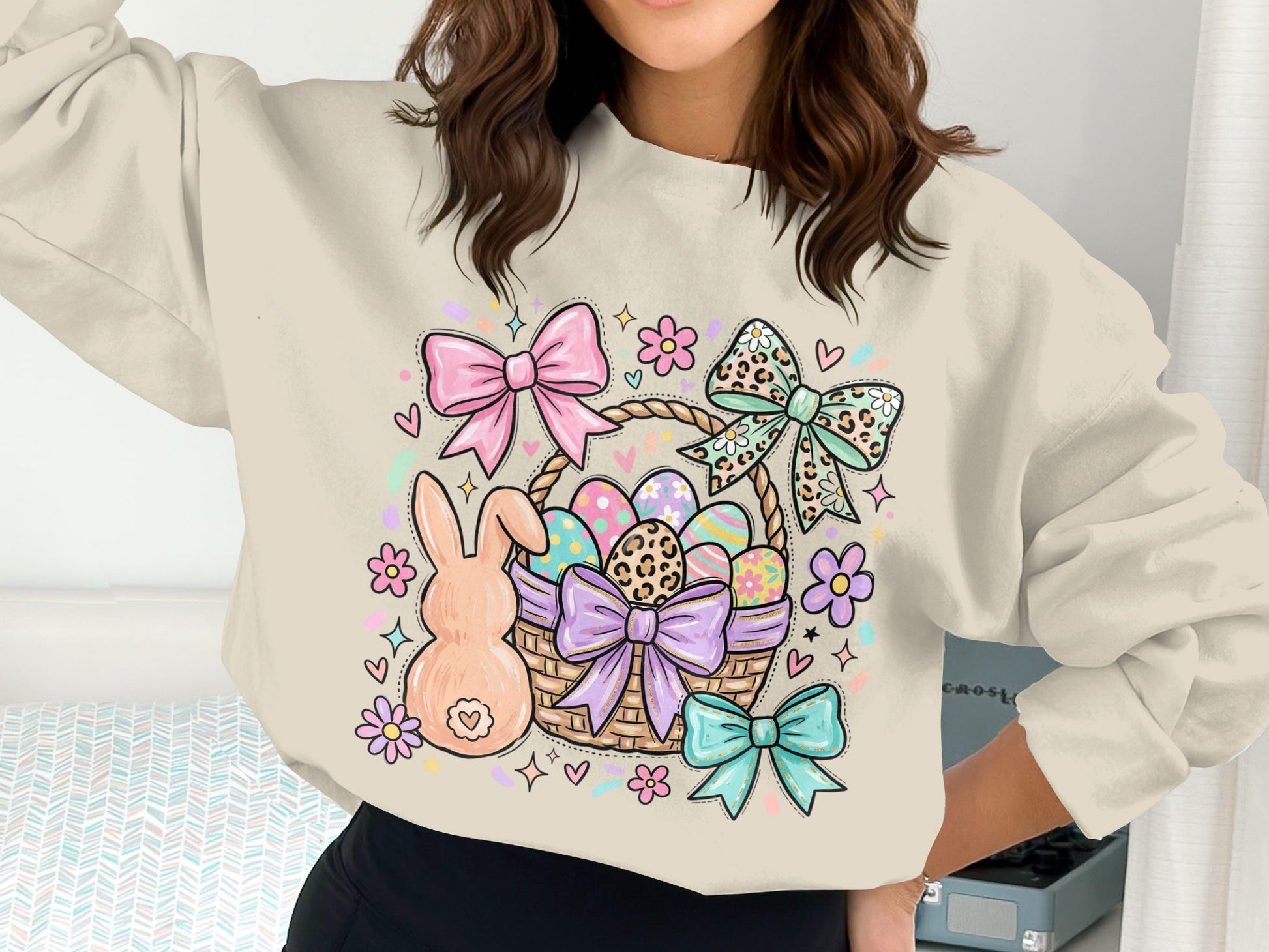 Easter basket with bunny, eggs, and colorful bows on a cream sweatshirt.