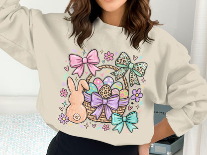 Easter basket with bunny, eggs, and colorful bows on a cream sweatshirt.