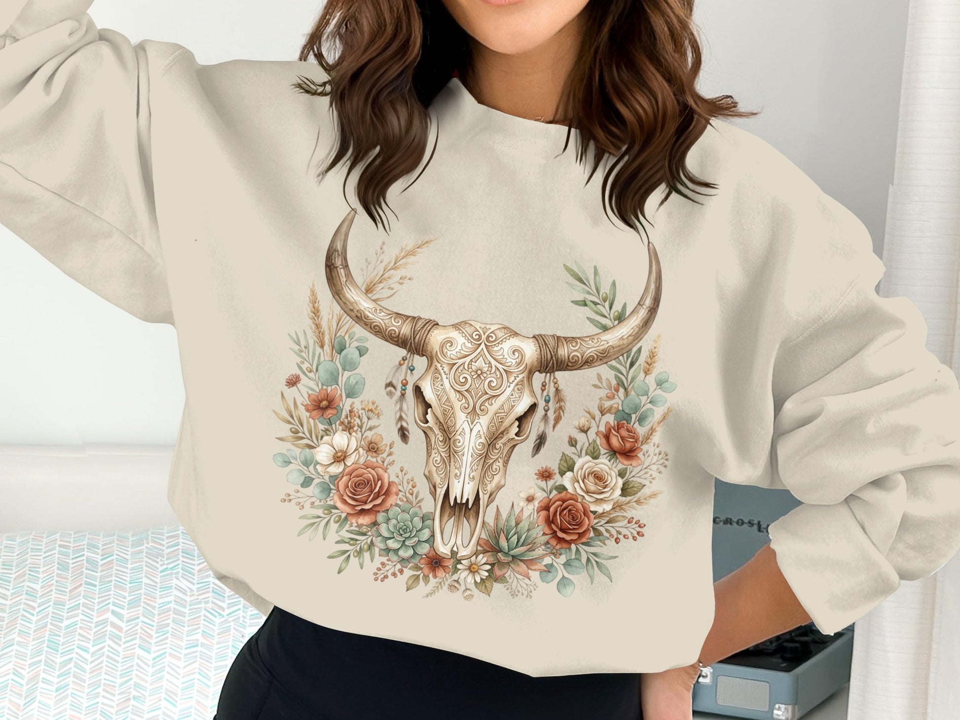 Cream sweatshirt with a bull skull and floral wreath design.