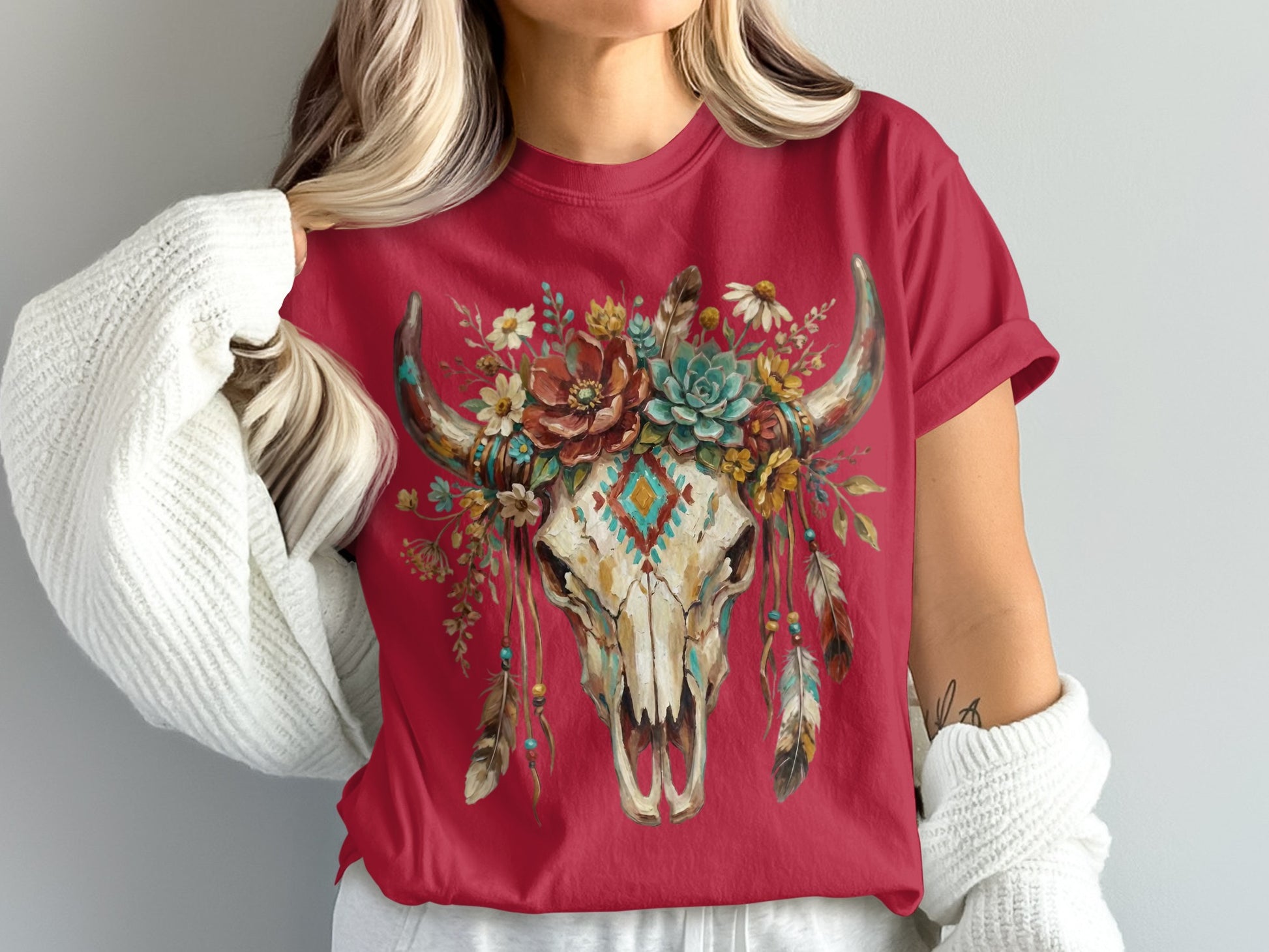 Red t-shirt with a decorative bull skull and floral design.