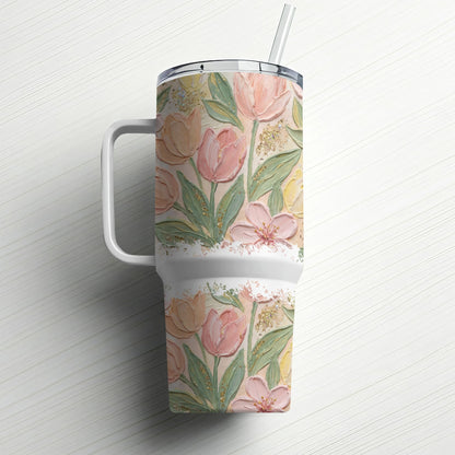 White tumbler with pink and yellow floral design and white handle.