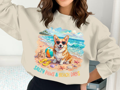 Corgi wearing heart sunglasses on a beach with "Salty Paws & Beach Days" text.