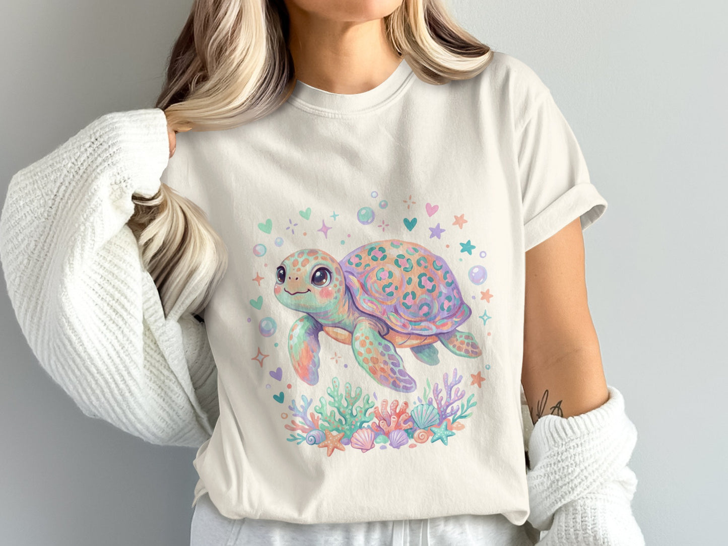 Cute watercolor turtle with coral and bubbles on a light t-shirt.