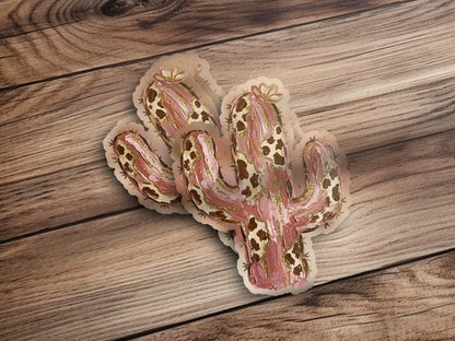 Saguaro cactus stickers with gold accents on a wooden surface.