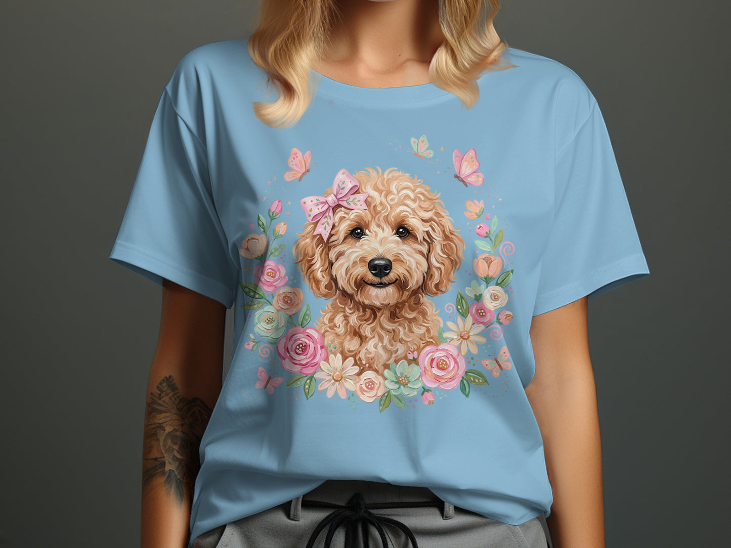 Light blue t-shirt with a poodle puppy in a floral wreath and butterflies.