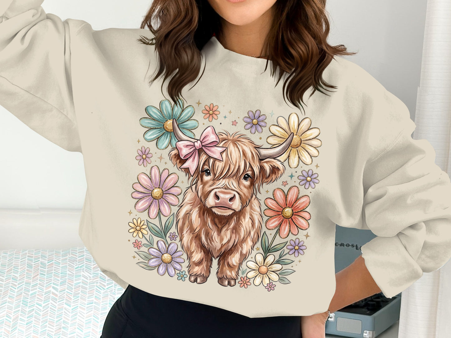 Crewneck sweatshirt featuring a fluffy Highland cow with a pink bow among pastel flowers.
