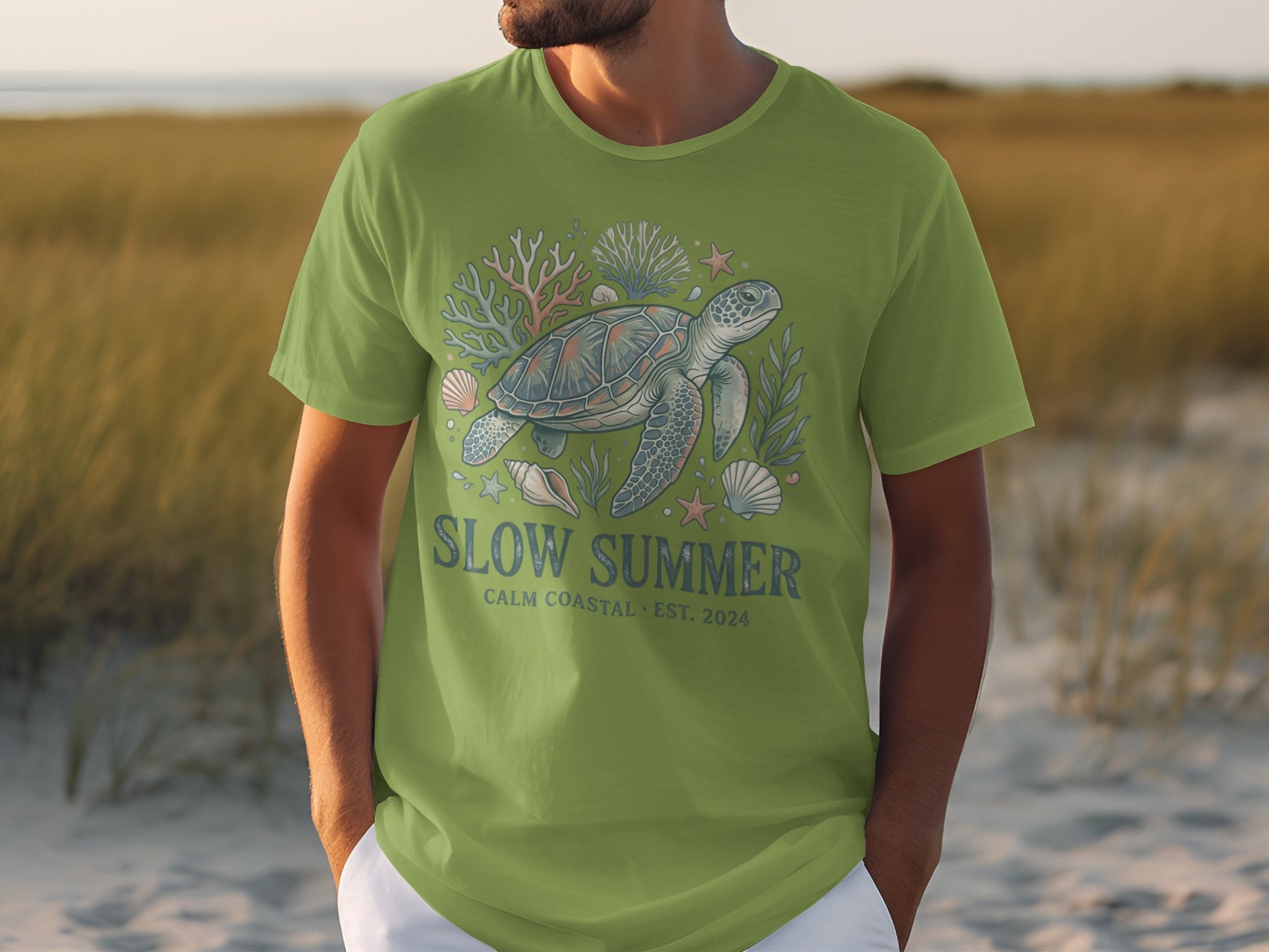 Green t-shirt with a sea turtle and coral graphic, text "SLOW SUMMER".