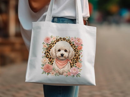 White tote bag with poodle illustration surrounded by flowers and leopard print.