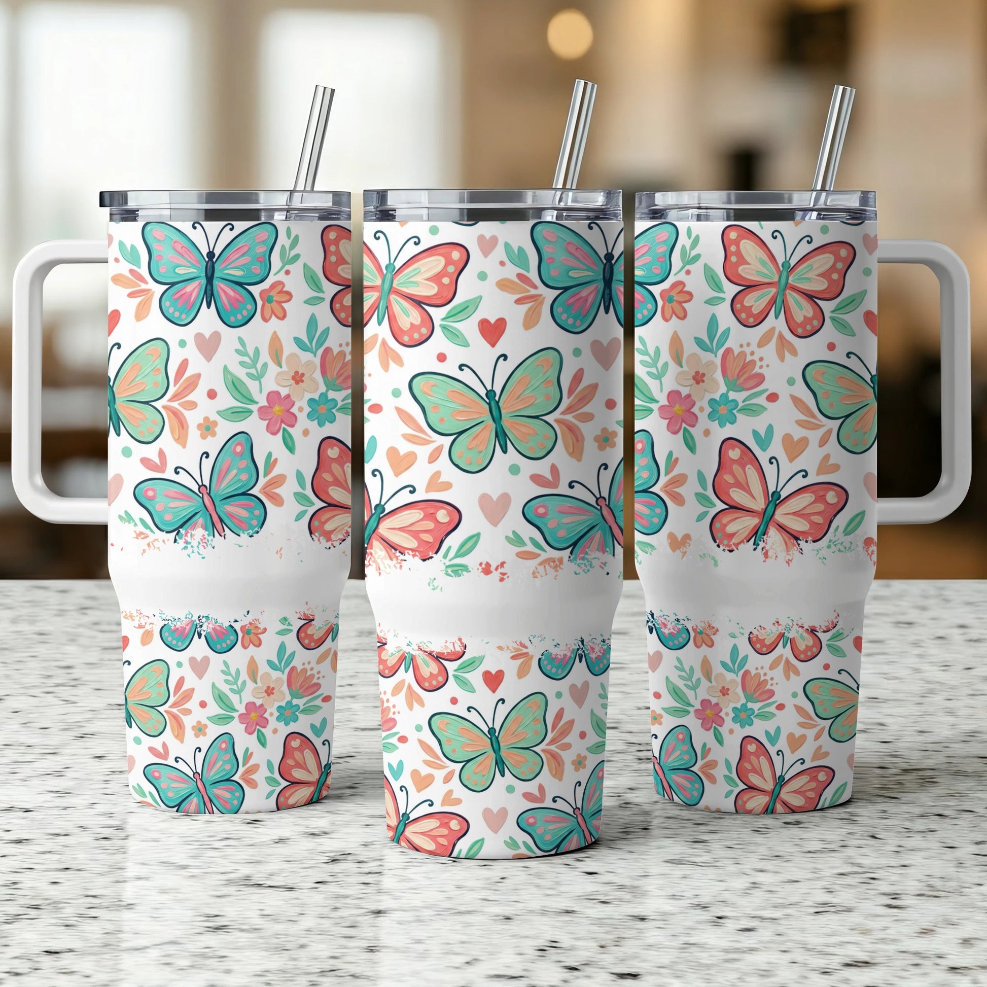 Three tumblers with a colorful butterfly and floral pattern, each with a white handle.