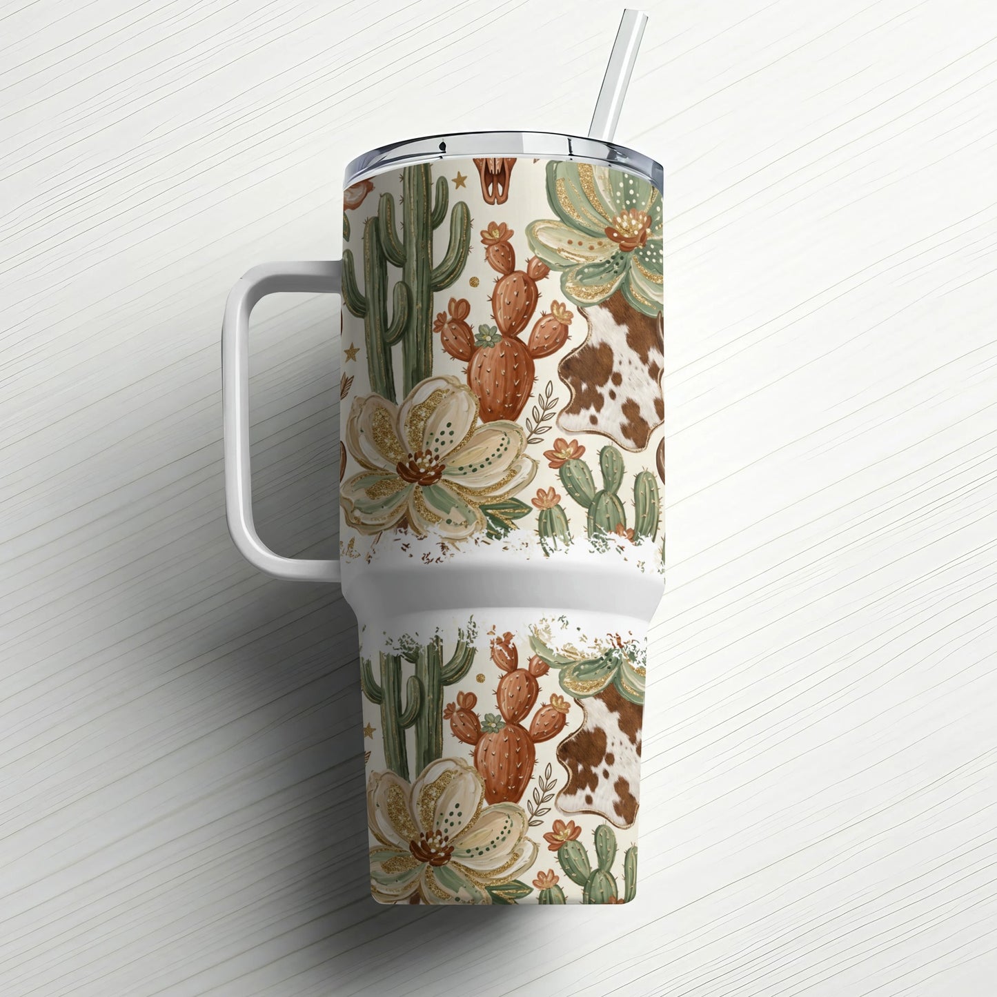 Western-themed tumbler with cacti, floral, and cowhide patterns, featuring a straw.
