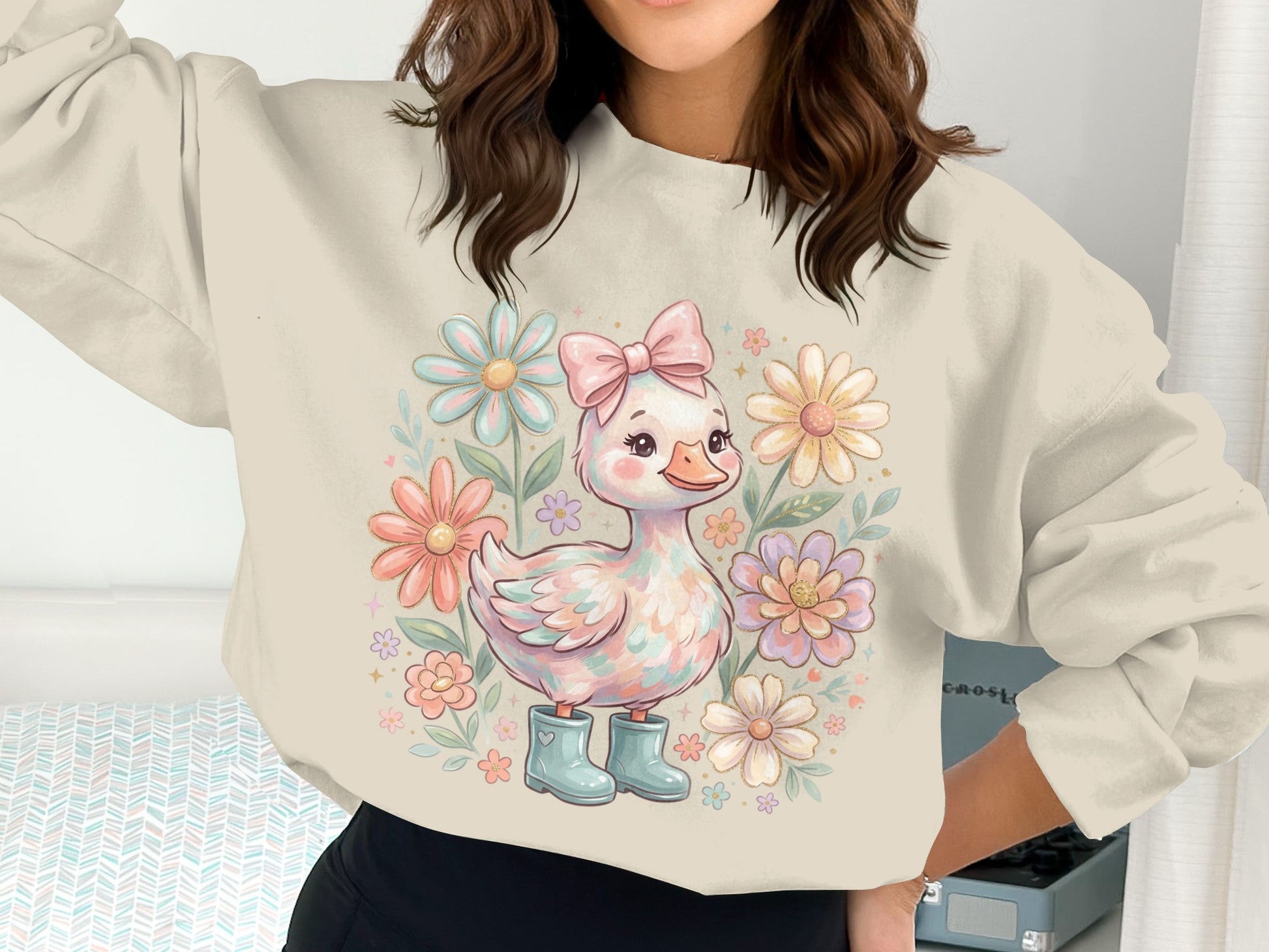 Sweatshirt with pastel duckling and flowers, featuring a pink bow.