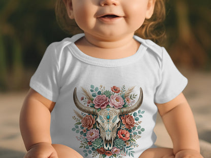 Baby in white bodysuit with bull skull and floral illustration.