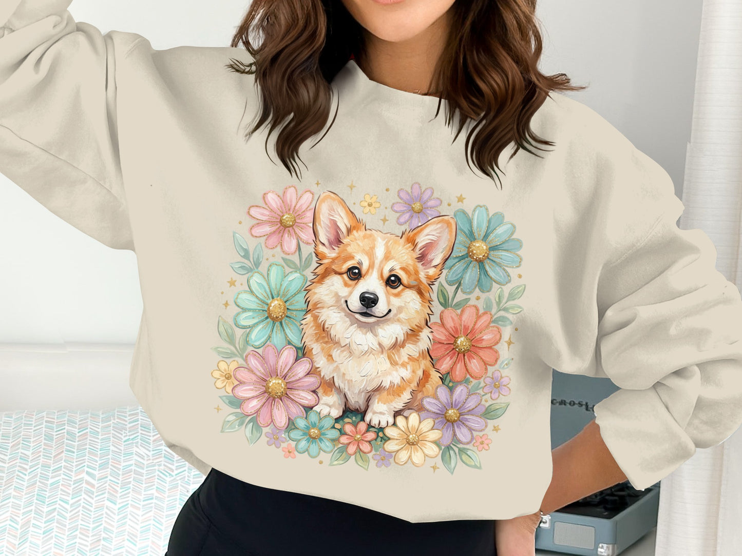 Corgi surrounded by colorful flowers on a cream sweatshirt.