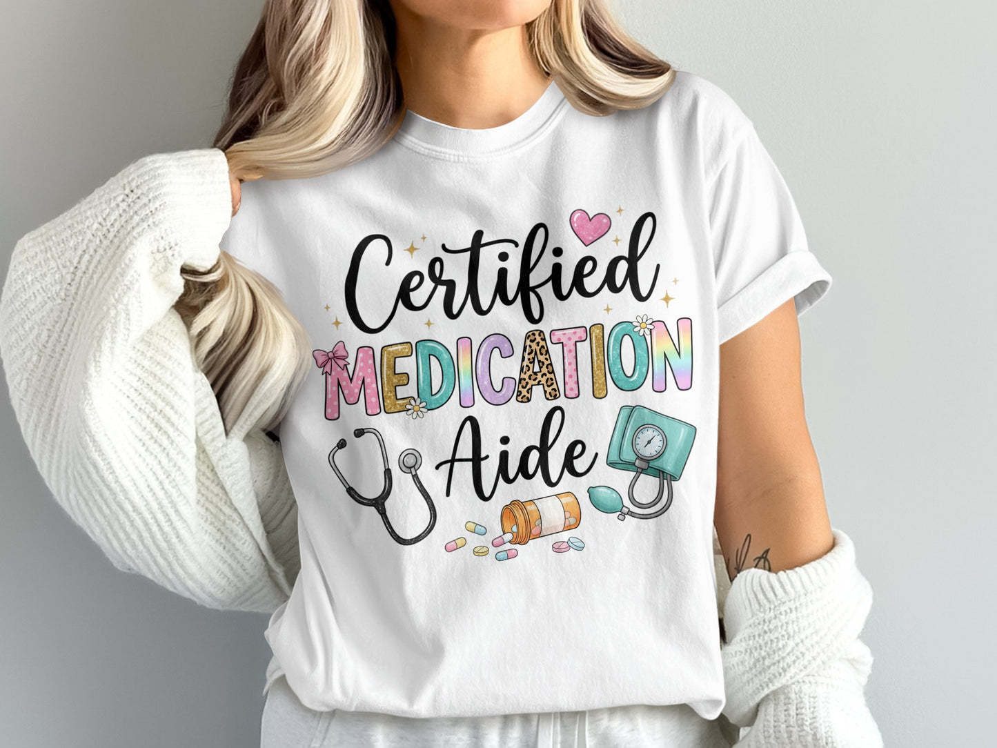 White t-shirt with "Certified Medication Aide" and medical icons in colorful lettering.