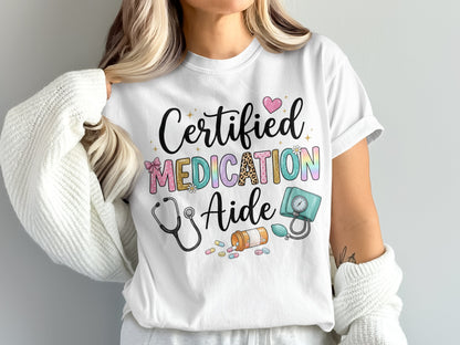 White t-shirt with "Certified Medication Aide" and medical icons in colorful lettering.