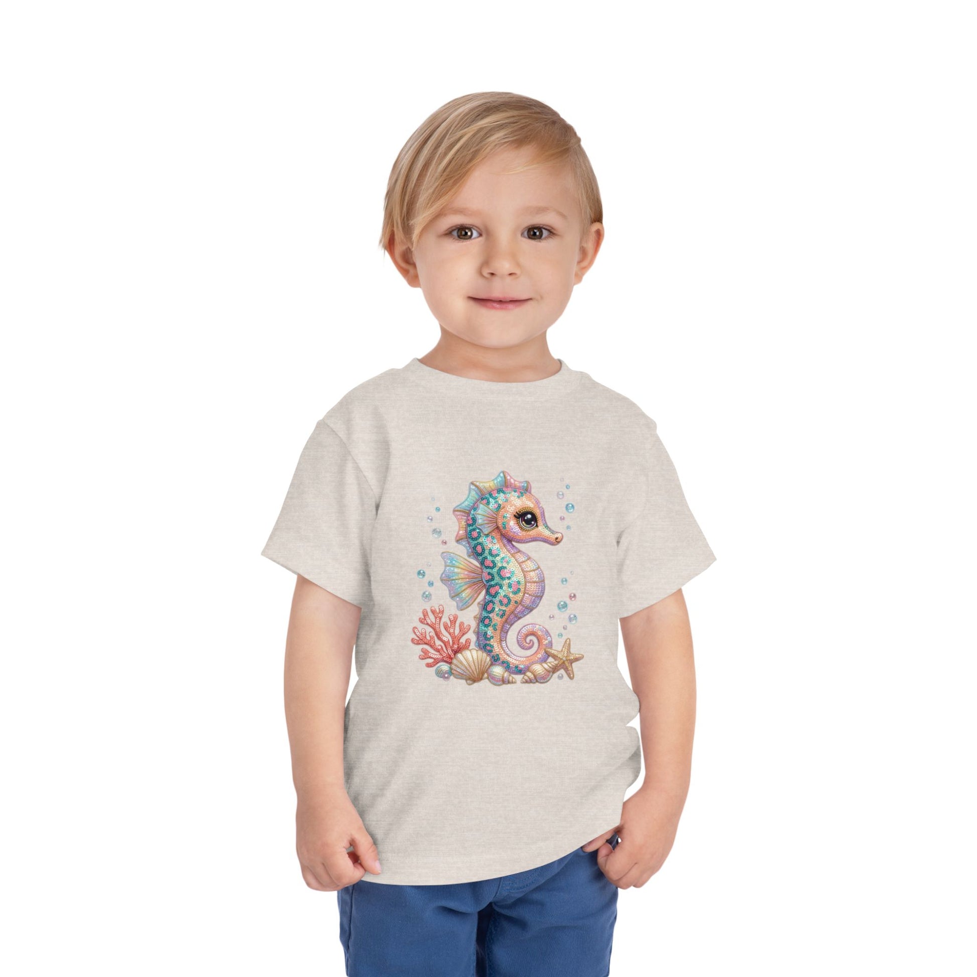Cream t-shirt with a cartoon seahorse, coral, and starfish design.