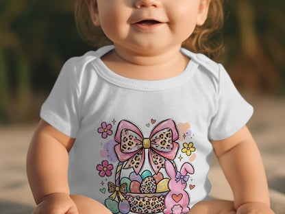 Baby in a white Easter-themed bodysuit with a bunny and decorated eggs.