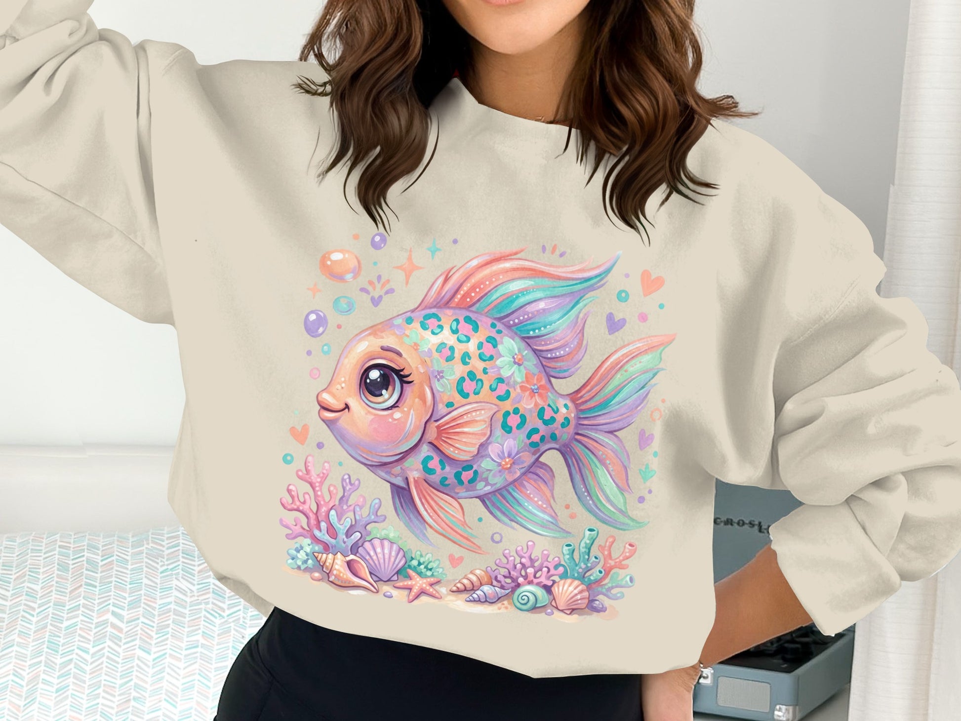 Colorful fish with floral patterns and seashells on a cream sweatshirt.