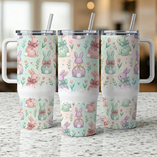 Three white tumblers with pastel Easter bunny and floral pattern.