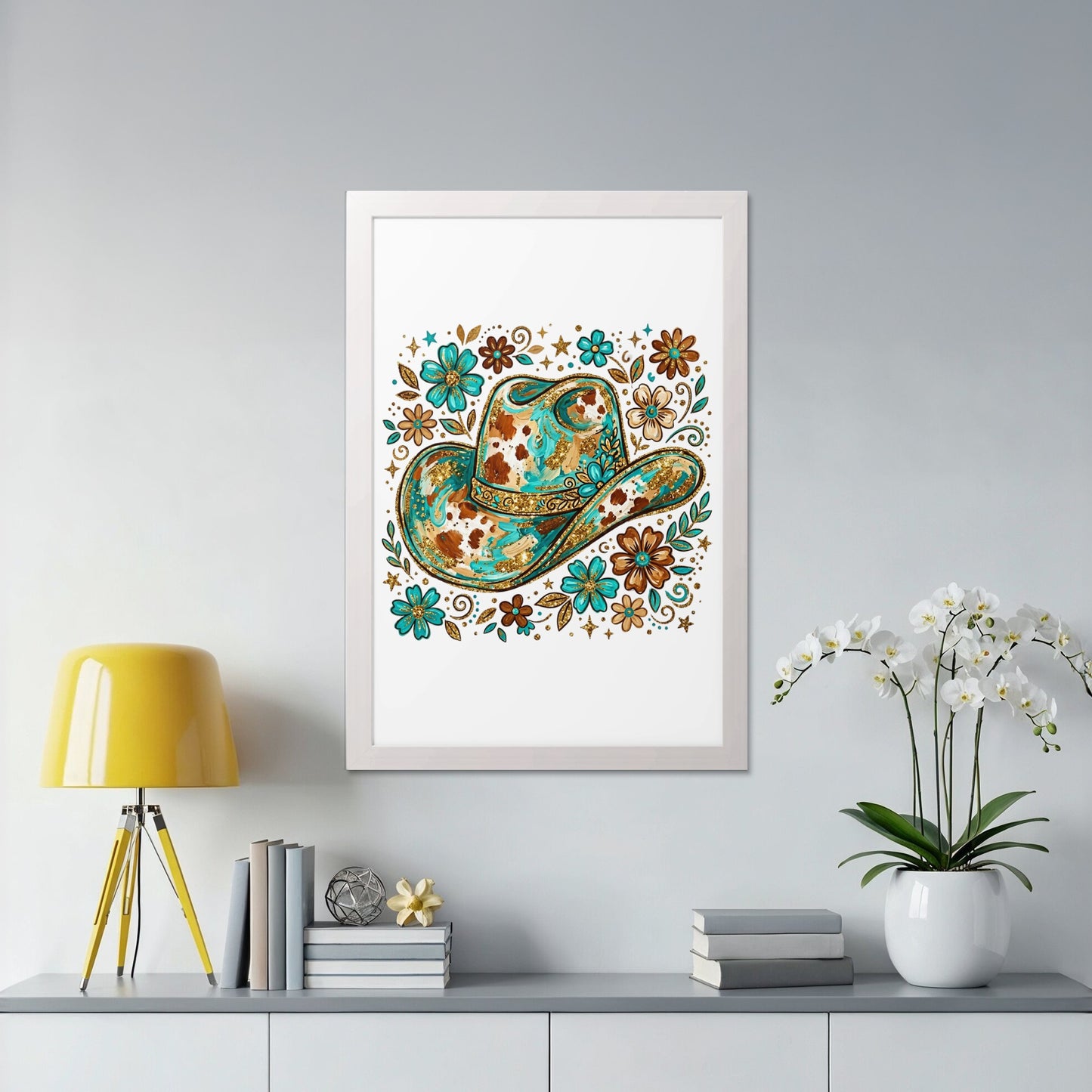White framed artwork featuring a colorful, ornate cowboy hat with floral accents.