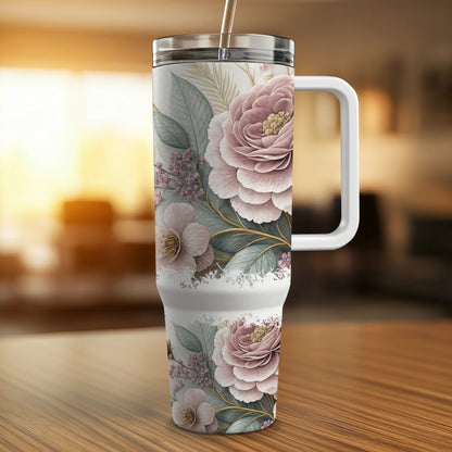 White tumbler with pink floral design and silver straw.