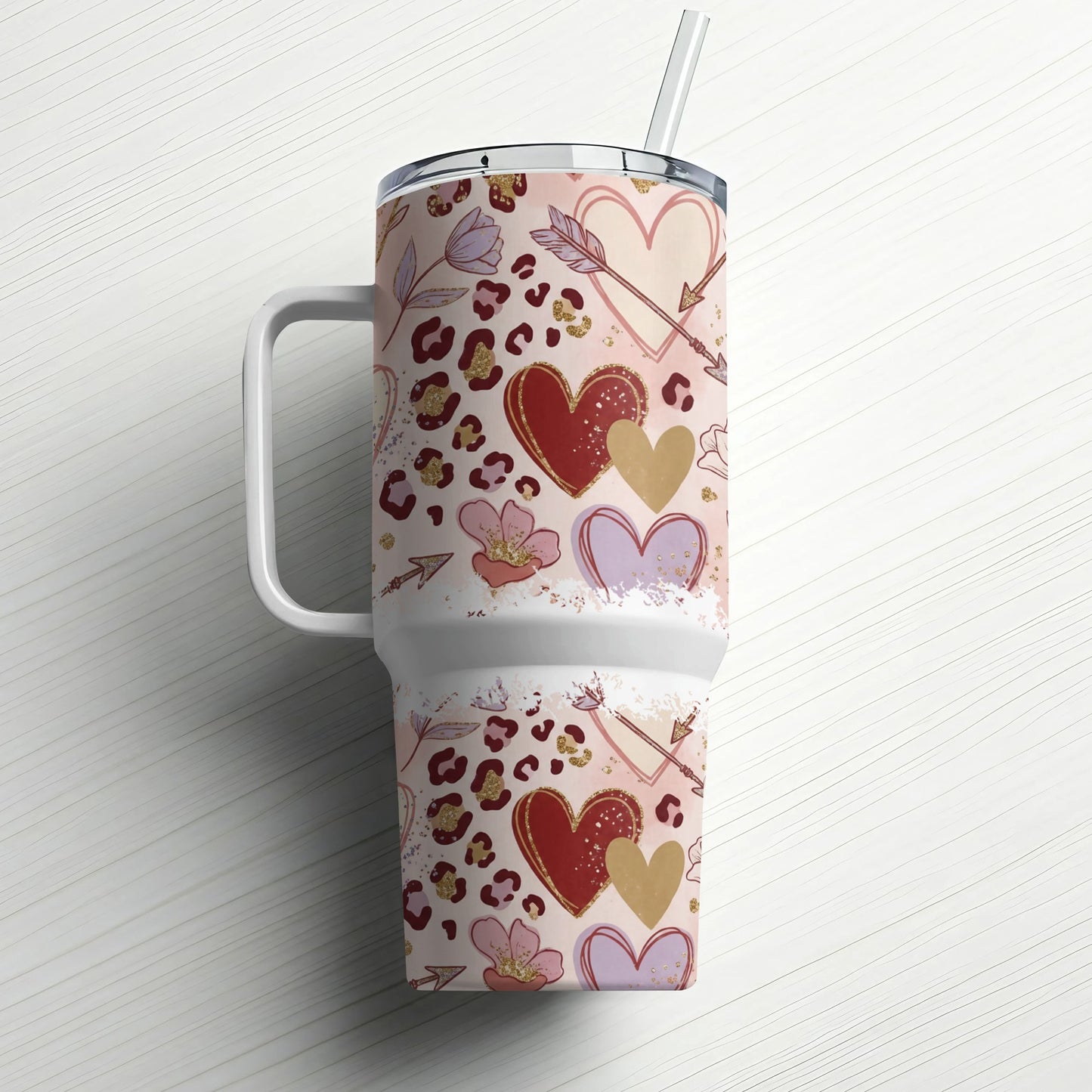 Tumbler with leopard print, hearts, flowers, and arrows pattern.