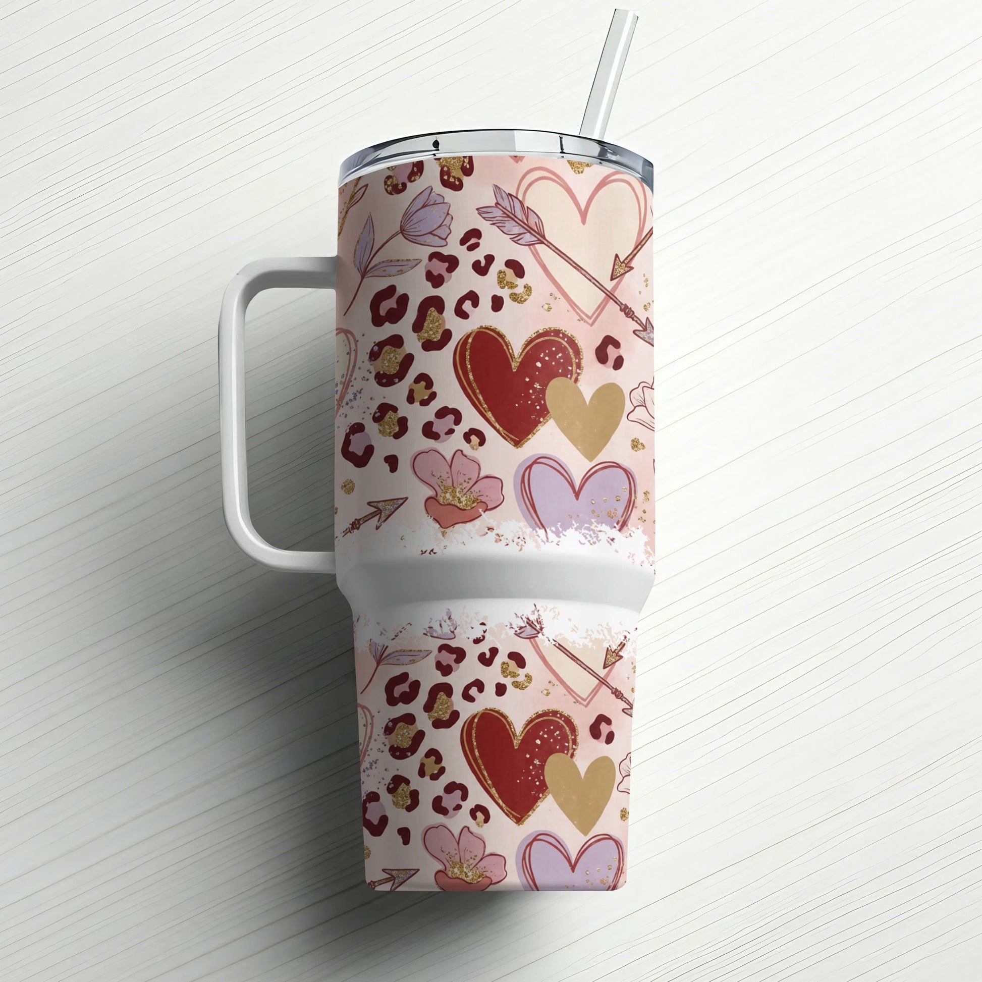Tumbler with leopard print, hearts, flowers, and arrows pattern.
