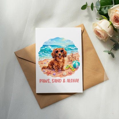 Dachshund in sunglasses at beach with text "Paws, Sand & Aloha!".