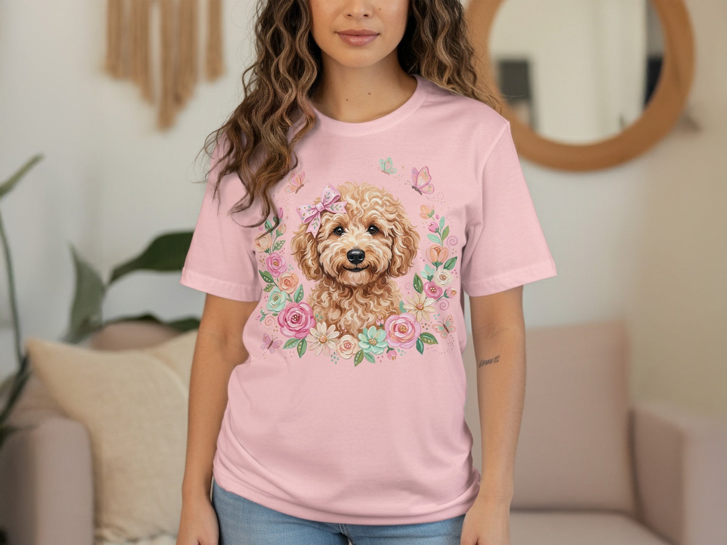 Pink t-shirt with a doodle dog surrounded by flowers and butterflies.