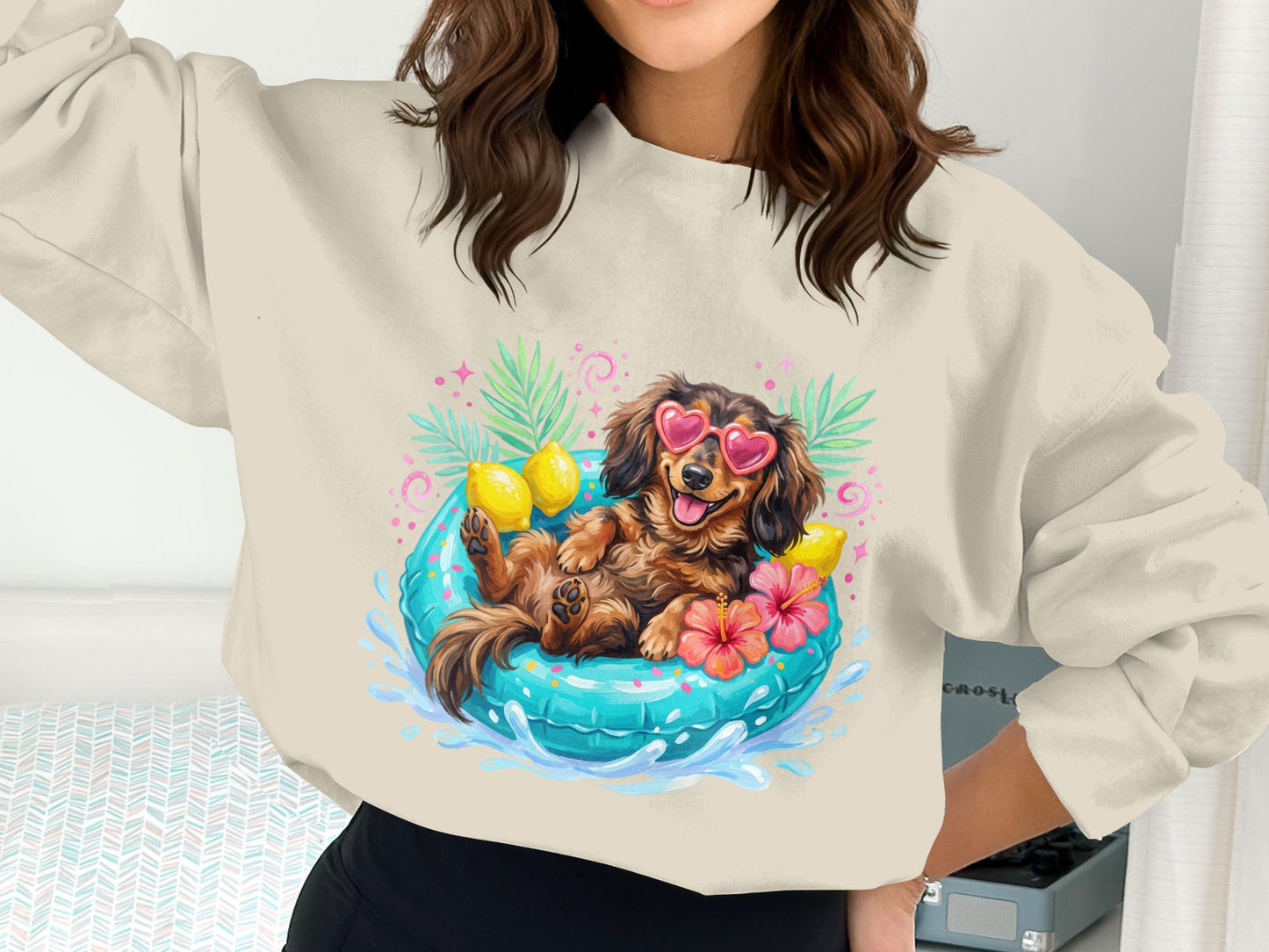 Sweatshirt with dachshund wearing sunglasses relaxing in a pool float.