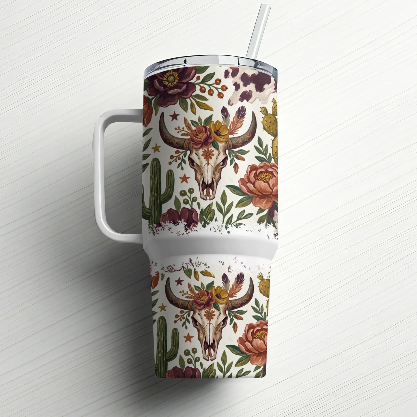 Floral skull and cactus pattern on a white tumbler with straw and handle.