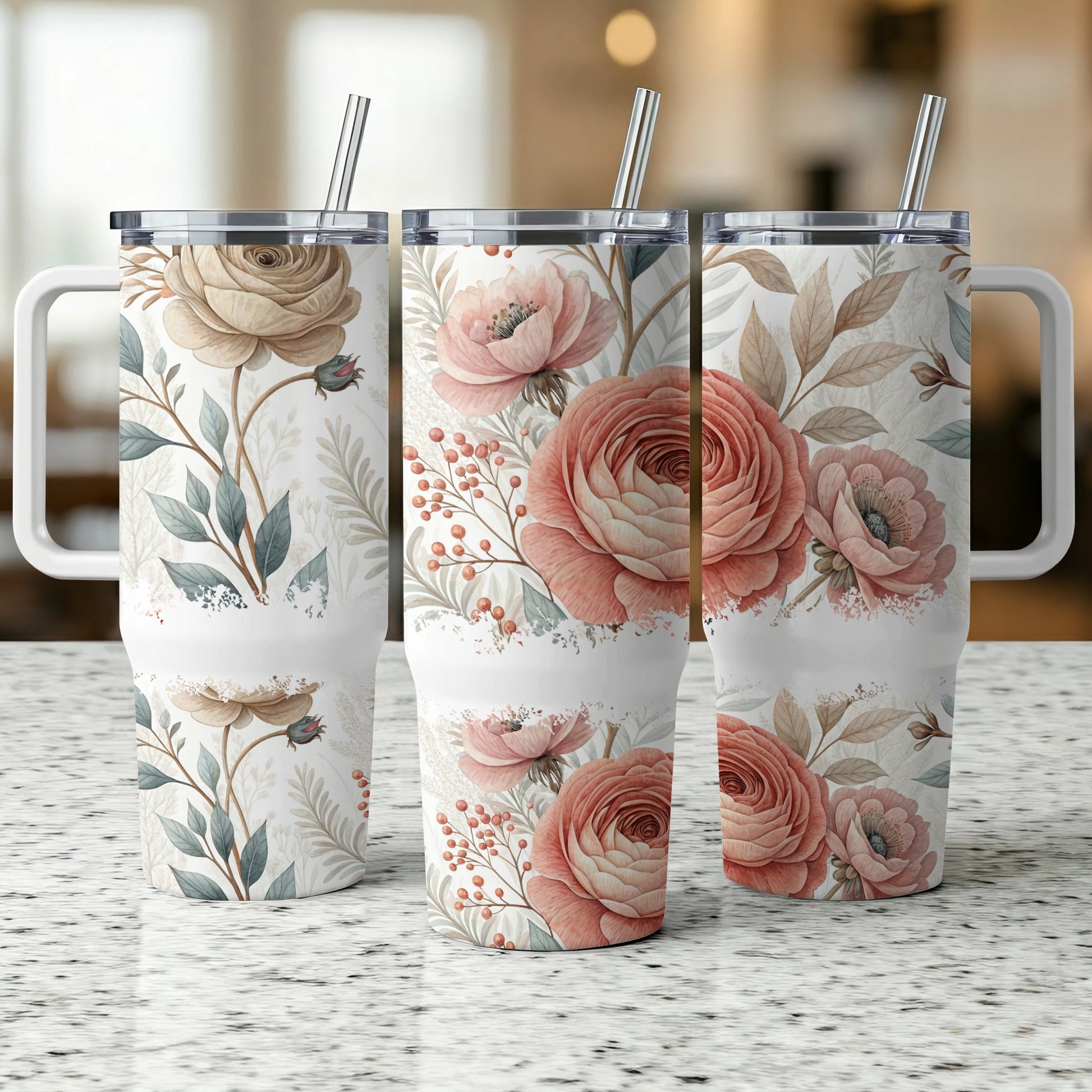 Three tumblers with floral patterns and stainless steel straws.