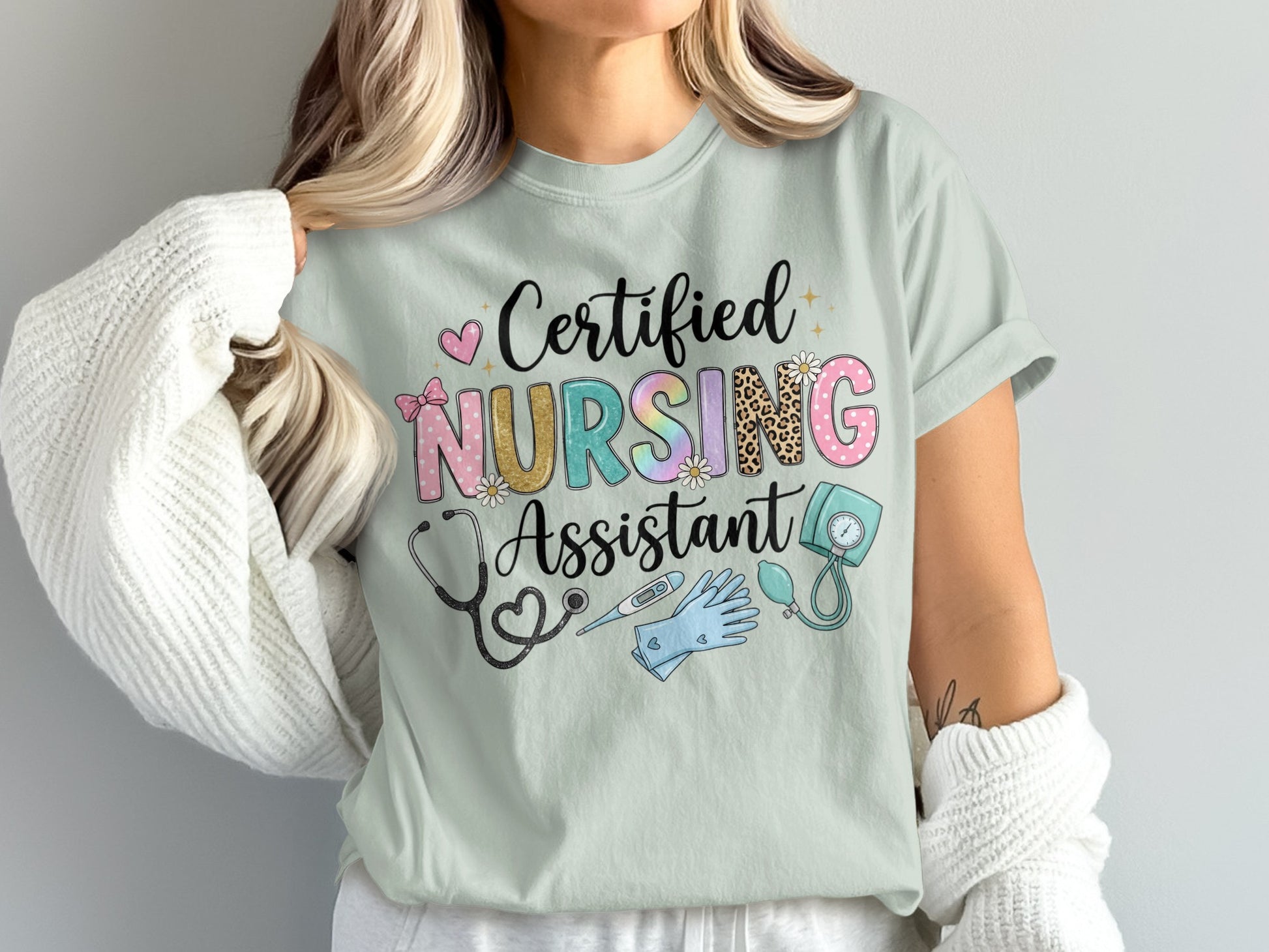 "Certified Nursing Assistant" text with medical icons on a light green t-shirt.